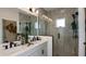 Modern bathroom with a double vanity, glass-enclosed shower, and elegant fixtures at 1617 Sea Haven Dr # 501, Punta Gorda, FL 33950