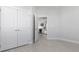 Neutral bedroom features wood look tile floors, closet and partial kitchen view at 1617 Sea Haven Dr # 501, Punta Gorda, FL 33950