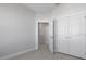 Neutral bedroom features wood look tile floors and closet space at 1617 Sea Haven Dr # 501, Punta Gorda, FL 33950
