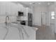 Bright kitchen showcasing white cabinets, stainless steel appliances, and marble countertops at 1617 Sea Haven Dr # 501, Punta Gorda, FL 33950