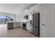 Open concept kitchen with white cabinetry, stainless appliances, and outdoor views at 1617 Sea Haven Dr # 501, Punta Gorda, FL 33950