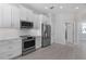 Modern kitchen with white cabinetry, stainless appliances, and sleek countertops at 1617 Sea Haven Dr # 501, Punta Gorda, FL 33950