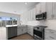 Well-lit kitchen featuring modern appliances, white cabinets, and an eat-in island at 1617 Sea Haven Dr # 501, Punta Gorda, FL 33950