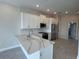 Modern kitchen boasts white cabinets, stainless steel appliances, and a stylish center island with quartz countertops at 1617 Sea Haven Dr # 501, Punta Gorda, FL 33950