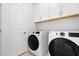 Well-equipped laundry room features a side-by-side washer and dryer with white cabinetry for storage and convenience at 1617 Sea Haven Dr # 501, Punta Gorda, FL 33950