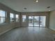 Bright living room with wood floors, large windows offering picturesque views, and access to a balcony at 1617 Sea Haven Dr # 501, Punta Gorda, FL 33950