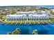 An aerial view showcases waterfront townhomes, manicured lawns, and boat docks on a sunny day at 1617 Sea Haven Dr # 502, Punta Gorda, FL 33950