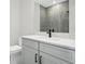 Modern bathroom featuring single vanity with quartz countertop, mirror, toilet and glass shower enclosure at 1617 Sea Haven Dr # 502, Punta Gorda, FL 33950