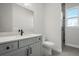 Bathroom featuring a single vanity with stone countertop, a mirror, toilet and shower with glass door at 1617 Sea Haven Dr # 502, Punta Gorda, FL 33950