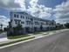 Attractive three-story townhouse units with manicured lawns and paved driveways on a sunny day at 1617 Sea Haven Dr # 502, Punta Gorda, FL 33950