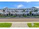 Attractive townhome-style condos with two stories, driveways, well-kept lawns, and palm trees under a partly cloudy sky at 1617 Sea Haven Dr # 502, Punta Gorda, FL 33950