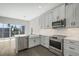 Bright kitchen features stainless steel appliances, gray cabinets, marble countertops and a breakfast bar at 1617 Sea Haven Dr # 502, Punta Gorda, FL 33950