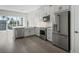 Modern, newly remodeled kitchen with stainless steel appliances, white cabinets, marble countertops, and hardwood floors at 1617 Sea Haven Dr # 502, Punta Gorda, FL 33950