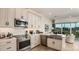 Modern kitchen features stainless steel appliances, bright white cabinets, and hardwood floors at 1617 Sea Haven Dr # 502, Punta Gorda, FL 33950