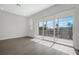 Bright living room with hardwood floors, large sliding glass doors leading to a balcony and lovely waterfront views at 1617 Sea Haven Dr # 502, Punta Gorda, FL 33950