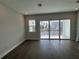 Bright living room with wood floors, sliding glass doors leading to a private balcony at 1617 Sea Haven Dr # 502, Punta Gorda, FL 33950