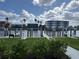 Waterfront view of a dock with boats, lush landscaping, and other residential buildings at 1617 Sea Haven Dr # 502, Punta Gorda, FL 33950