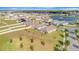 Sweeping aerial view of the community featuring well-maintained lawns and neighborhood ponds at 16341 Little Garden Dr, Wimauma, FL 33598