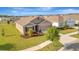 Broad aerial shot highlighting the property's location, landscaping, and its setting within a residential neighborhood at 16341 Little Garden Dr, Wimauma, FL 33598