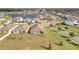 Panoramic aerial view showcases a tranquil community with lush landscaping, serene ponds, and well-spaced homes at 16341 Little Garden Dr, Wimauma, FL 33598