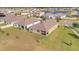 Aerial view of a community with manicured lawns and a pond at 16341 Little Garden Dr, Wimauma, FL 33598