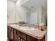 Bathroom featuring a double sink vanity with neutral countertops and stylish fixtures at 16341 Little Garden Dr, Wimauma, FL 33598