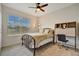 Bedroom with a fan, desk and a large window at 16341 Little Garden Dr, Wimauma, FL 33598