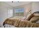 Bedroom with a ceiling fan and large window at 16341 Little Garden Dr, Wimauma, FL 33598