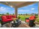 A covered patio with outdoor seating provides a relaxing space with views of the backyard at 16341 Little Garden Dr, Wimauma, FL 33598