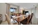 Dining room features a long wooden table with seating for six and sliding doors to the patio at 16341 Little Garden Dr, Wimauma, FL 33598