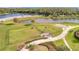 Aerial view of a well-maintained dog park with fenced areas, landscaping, and walking paths at 16341 Little Garden Dr, Wimauma, FL 33598