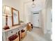The entryway has a wood table, lamp and bench at 16341 Little Garden Dr, Wimauma, FL 33598