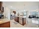 Open concept kitchen with granite countertops, an island, stainless appliances, and tile flooring at 16341 Little Garden Dr, Wimauma, FL 33598