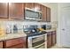 Modern kitchen features stainless steel appliances, granite countertops, and stylish backsplash at 16341 Little Garden Dr, Wimauma, FL 33598