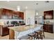 Kitchen featuring a large island with seating, stainless steel appliances, and tile flooring at 16341 Little Garden Dr, Wimauma, FL 33598