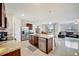 Open concept kitchen with granite countertops, an island, stainless appliances, and tile flooring at 16341 Little Garden Dr, Wimauma, FL 33598