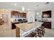 Kitchen featuring a large island with seating, stainless steel appliances, and tile flooring at 16341 Little Garden Dr, Wimauma, FL 33598