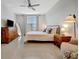 Well-lit bedroom showcases a bed, dresser, and stylish accents, creating a serene retreat at 16341 Little Garden Dr, Wimauma, FL 33598