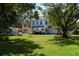 Expansive backyard featuring lush lawn, mature trees, and detached garage at 1704 4Th W St, Palmetto, FL 34221