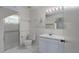 Clean bathroom with tiled floors, shower, vanity, and well-lit mirror at 1704 4Th W St, Palmetto, FL 34221