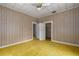 Bedroom featuring a closet, ceiling fan, and adjacent room with open doors at 1704 4Th W St, Palmetto, FL 34221