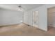 Spacious bedroom with neutral carpet, a ceiling fan, and an adjoining bathroom at 1704 4Th W St, Palmetto, FL 34221