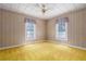 Cozy bedroom with two bright windows, wood paneling, and ceiling fan at 1704 4Th W St, Palmetto, FL 34221