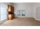 Neutral carpeted room with vintage built-in cabinet and ample natural light at 1704 4Th W St, Palmetto, FL 34221