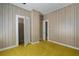 Bedroom with doors and wood paneling complemented by the unique yellow carpet at 1704 4Th W St, Palmetto, FL 34221