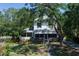 Attractive two-story home with a screened porch, surrounded by beautiful, mature trees at 1704 4Th W St, Palmetto, FL 34221
