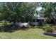 Quaint two-story home with a screened in porch and mature trees lining the landscaped yard at 1704 4Th W St, Palmetto, FL 34221