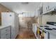 Functional kitchen features white cabinets, a refrigerator, and essential appliances at 1704 4Th W St, Palmetto, FL 34221