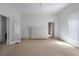 Spacious carpeted living room with a brick fireplace and white-paneled walls at 1704 4Th W St, Palmetto, FL 34221