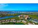 Scenic aerial view of waterfront community with lush landscaping, stunning beaches, and a beautiful coastal skyline at 1712 Starling Dr # 101, Sarasota, FL 34231